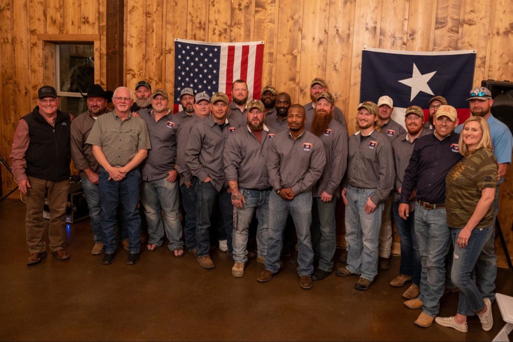 The warriors (in gray) pose for a group photo with many of the supporters of LSWO. Photo by Michael Herne/Coffee or Die.