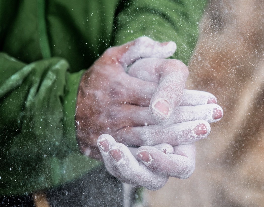 chalked hands for bouldering