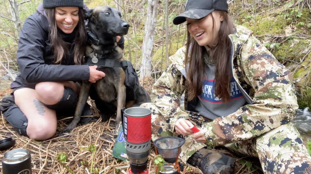 laura zerra and heather  making coffee in the woods