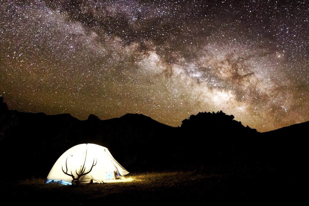 rack in tent at night under starry sky