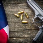 Pistol bullets, handgun and USA flag.