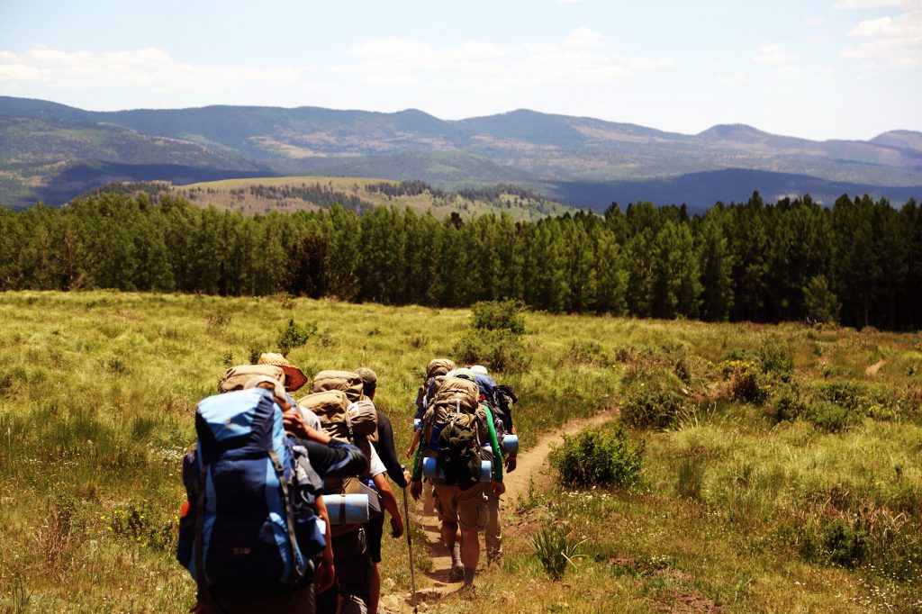 group of hikers with camping gear