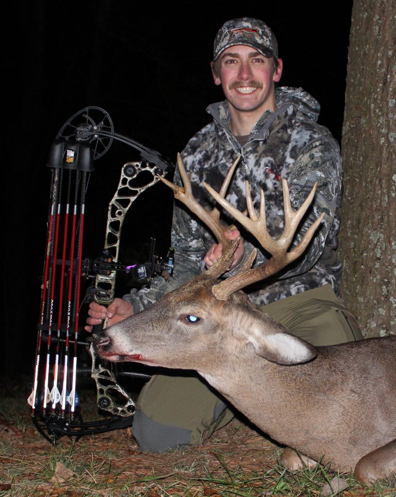 bowhunter with whitetail buck