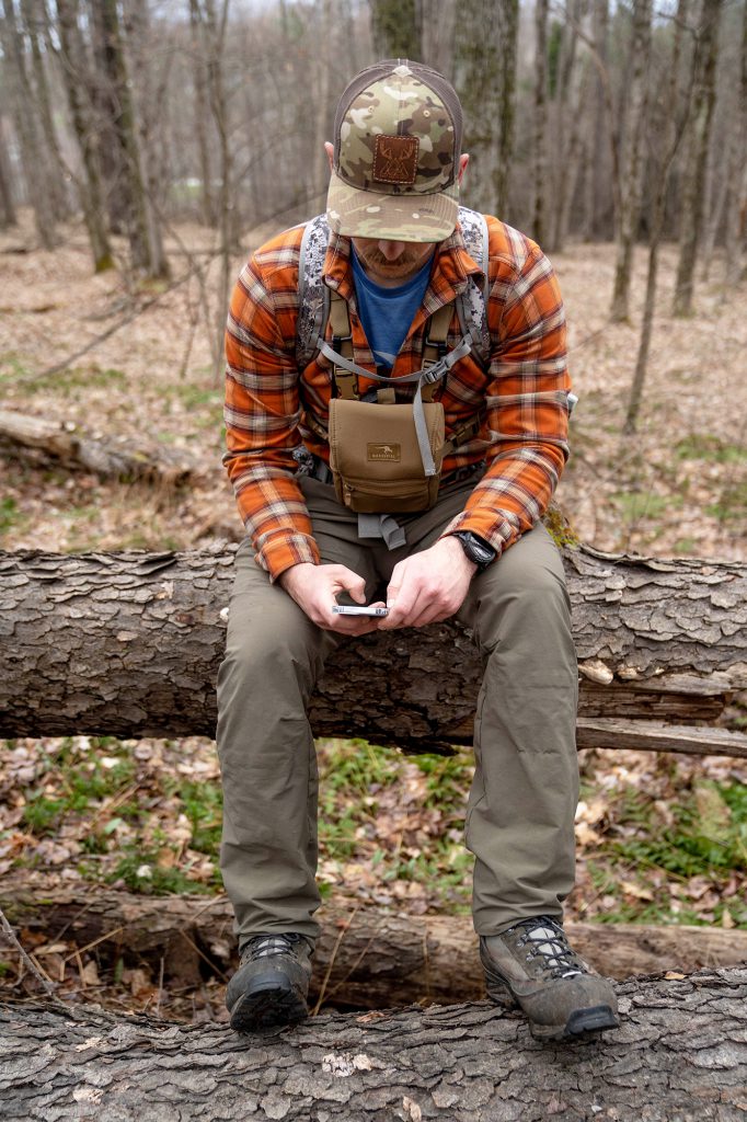 hunter using phone while scouting