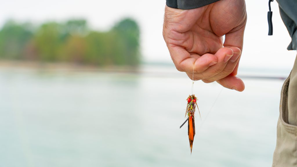 Fisherman standing by water