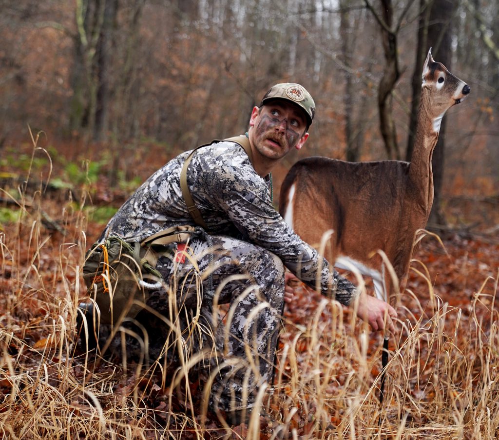 hunter setting up doe decoy while figuring out how to hunt public land