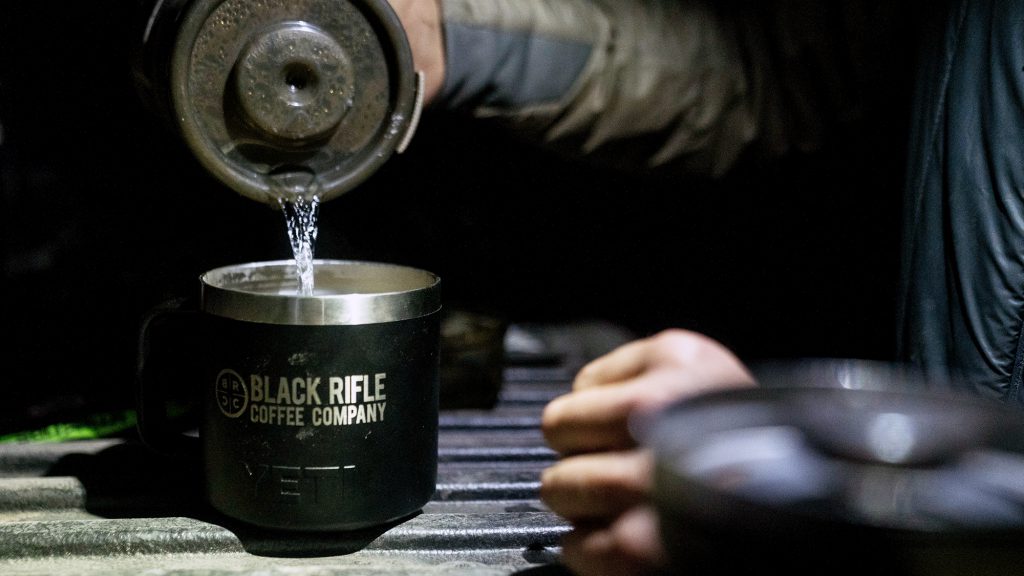 pouring water into coffee cup