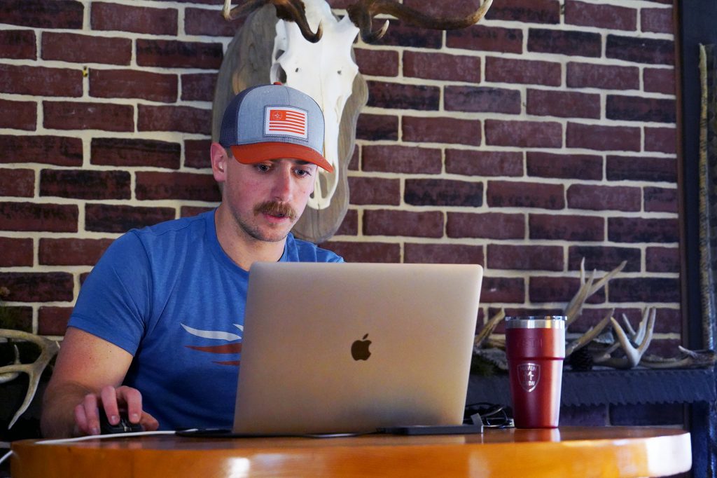 man doing research on laptop