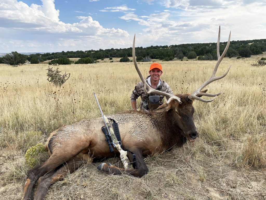 hunter with bull in field