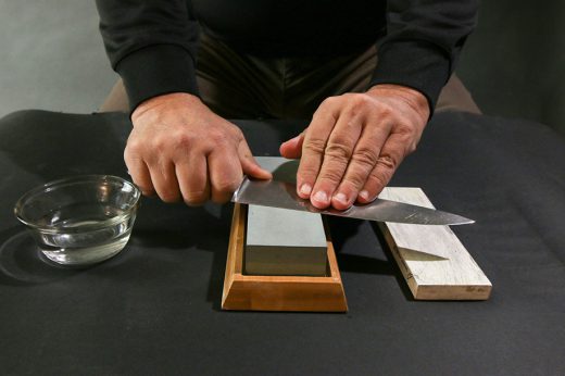 sharpening a knife on a whetstone