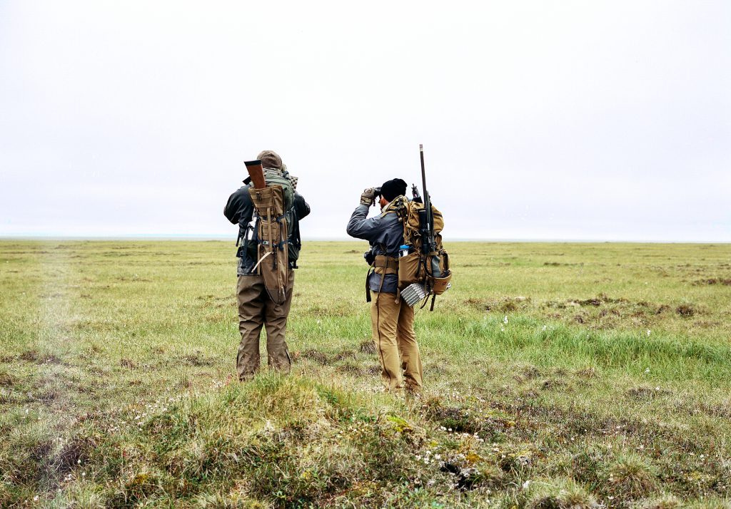 two hunters glassing tundra