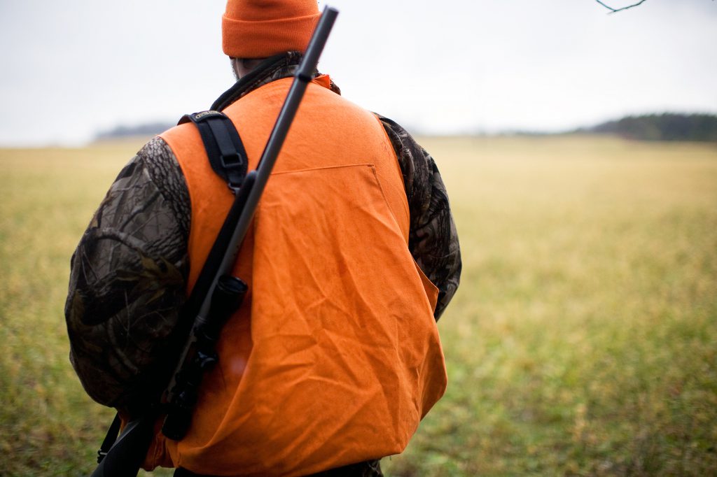 hunter in orange vest