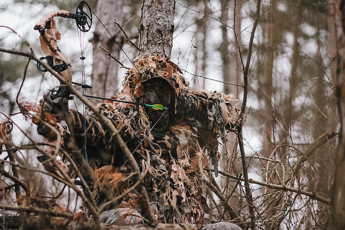 Bow hunter in a hunting ghillie suit