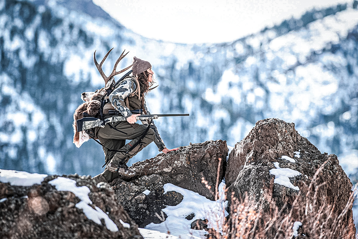Woman hunting on the mountain with Savage Arms 110 Timberline