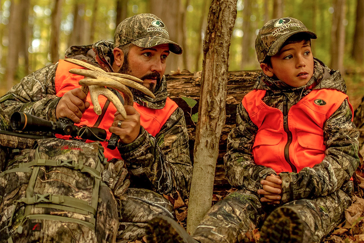 Mossy Oak Deer Hunting wearing orange vests