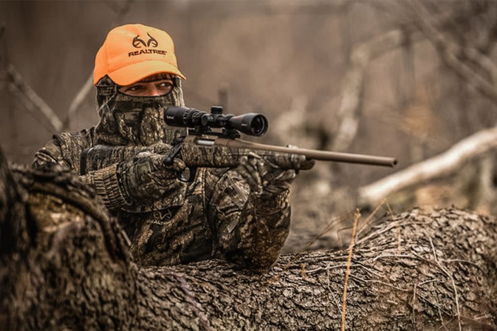 Realtree hunter with orange hat