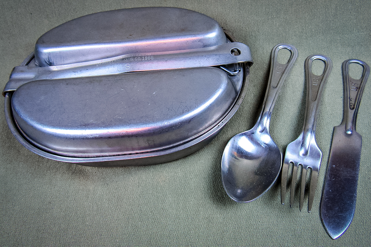 A U.S. Army 1965 meat can and silverware.