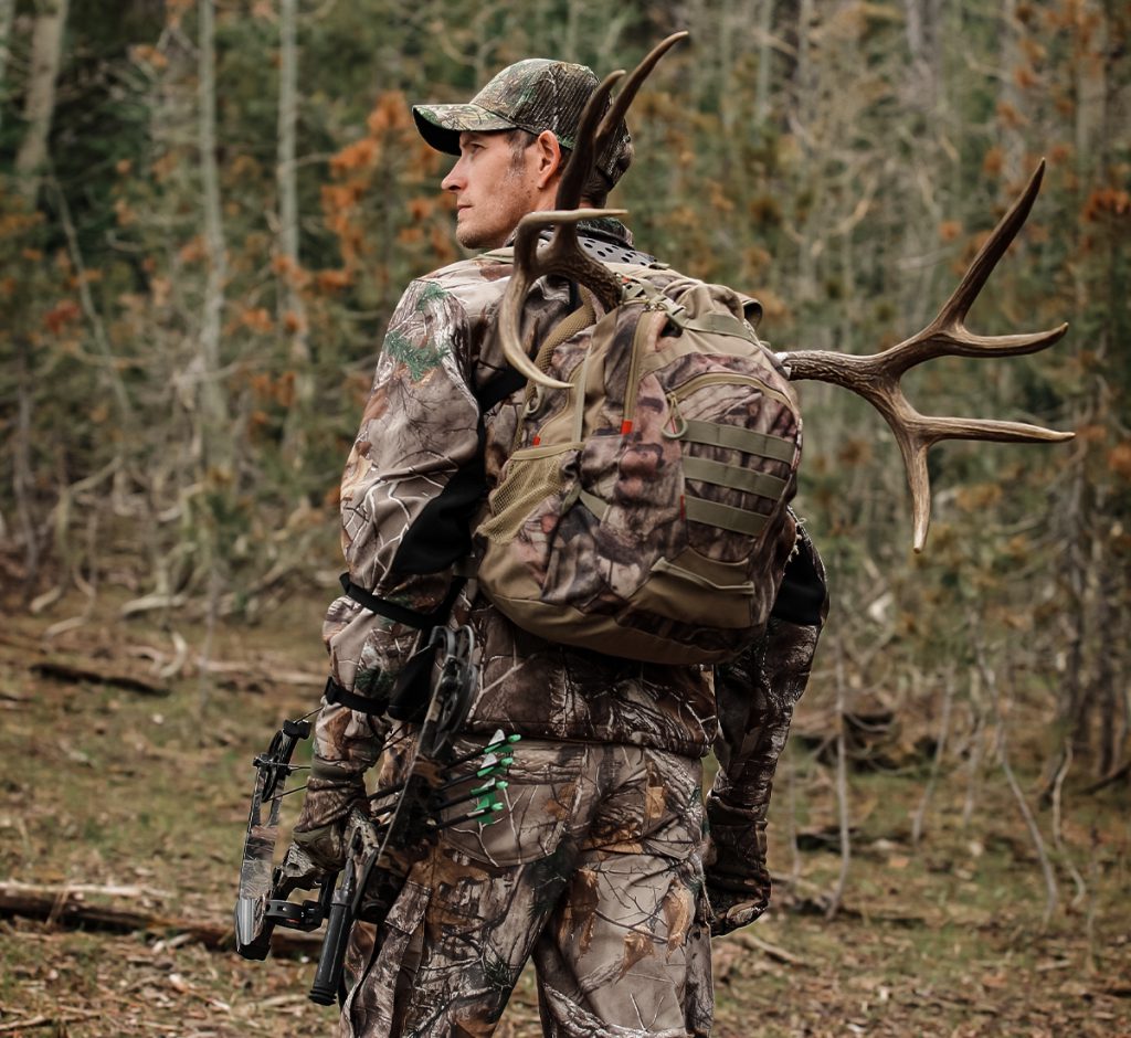 Archery hunter leaving the woods after a successful hunt