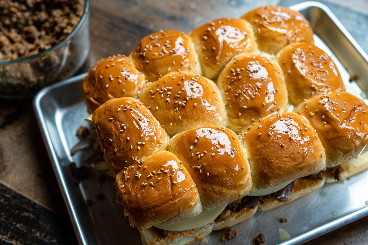 Before the Hawaiin burgers go in the oven, brush them with melted butter and sprinkle some white sesame seeds.